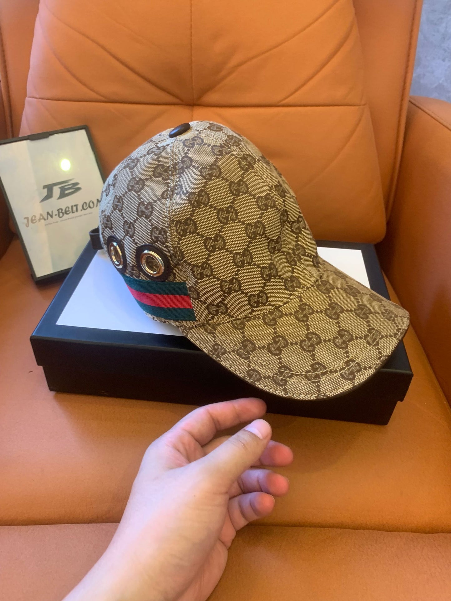 Gucci GG Supreme baseball cap with signature web stripe and metal eyelets