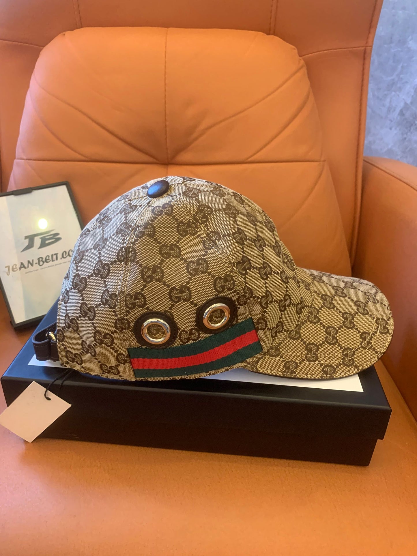 Gucci GG Supreme baseball cap with signature web stripe and metal eyelets