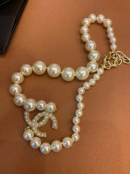 Chanel pearl necklace with signature CC pendant and crystal