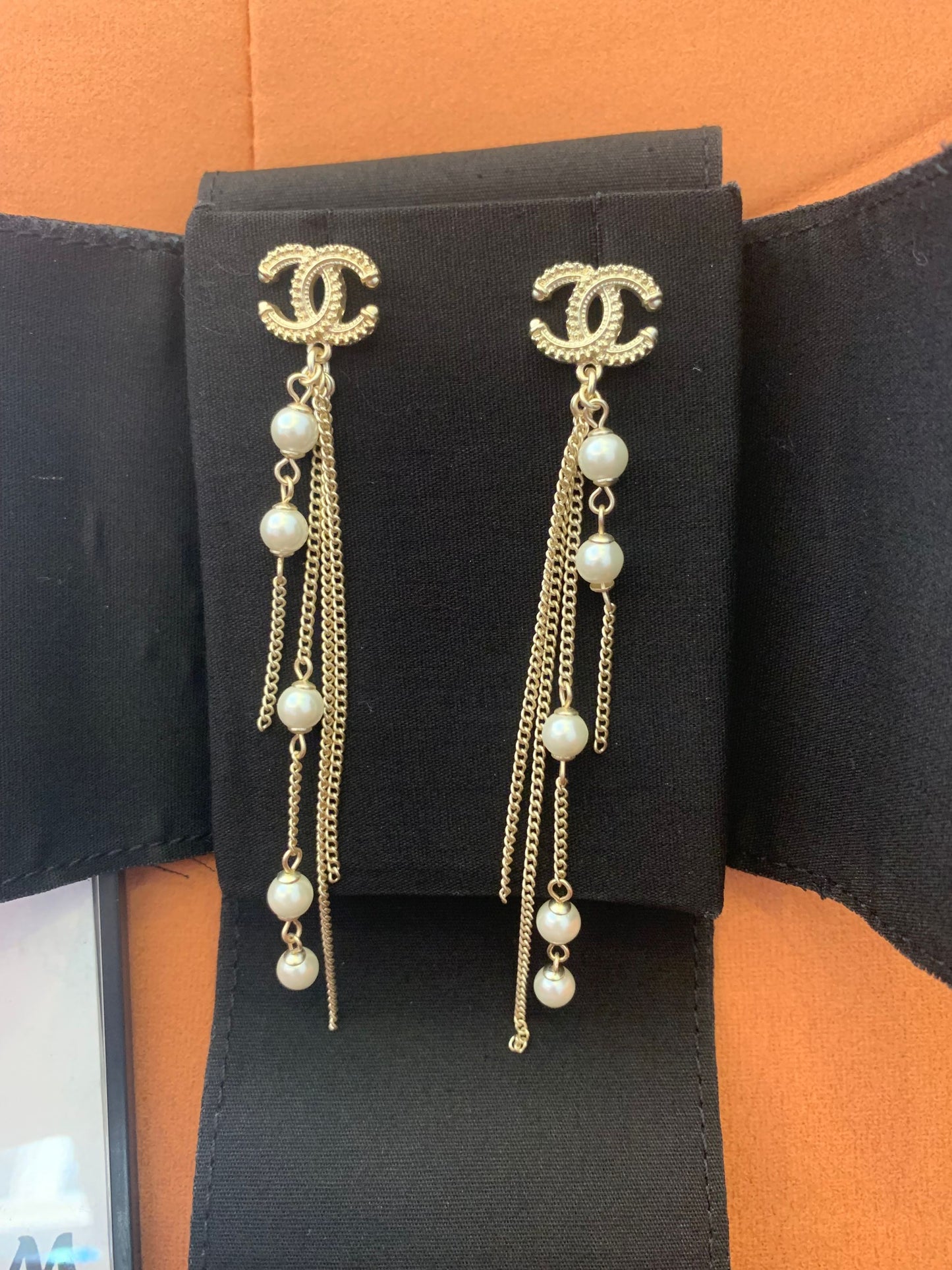 Chanel dangle earrings with CC logo and pearl accents