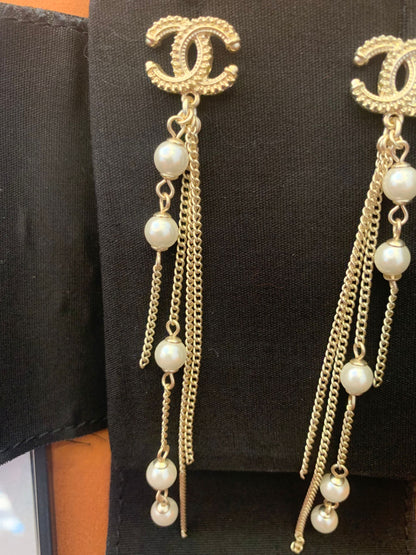 Chanel dangle earrings with CC logo and pearl accents