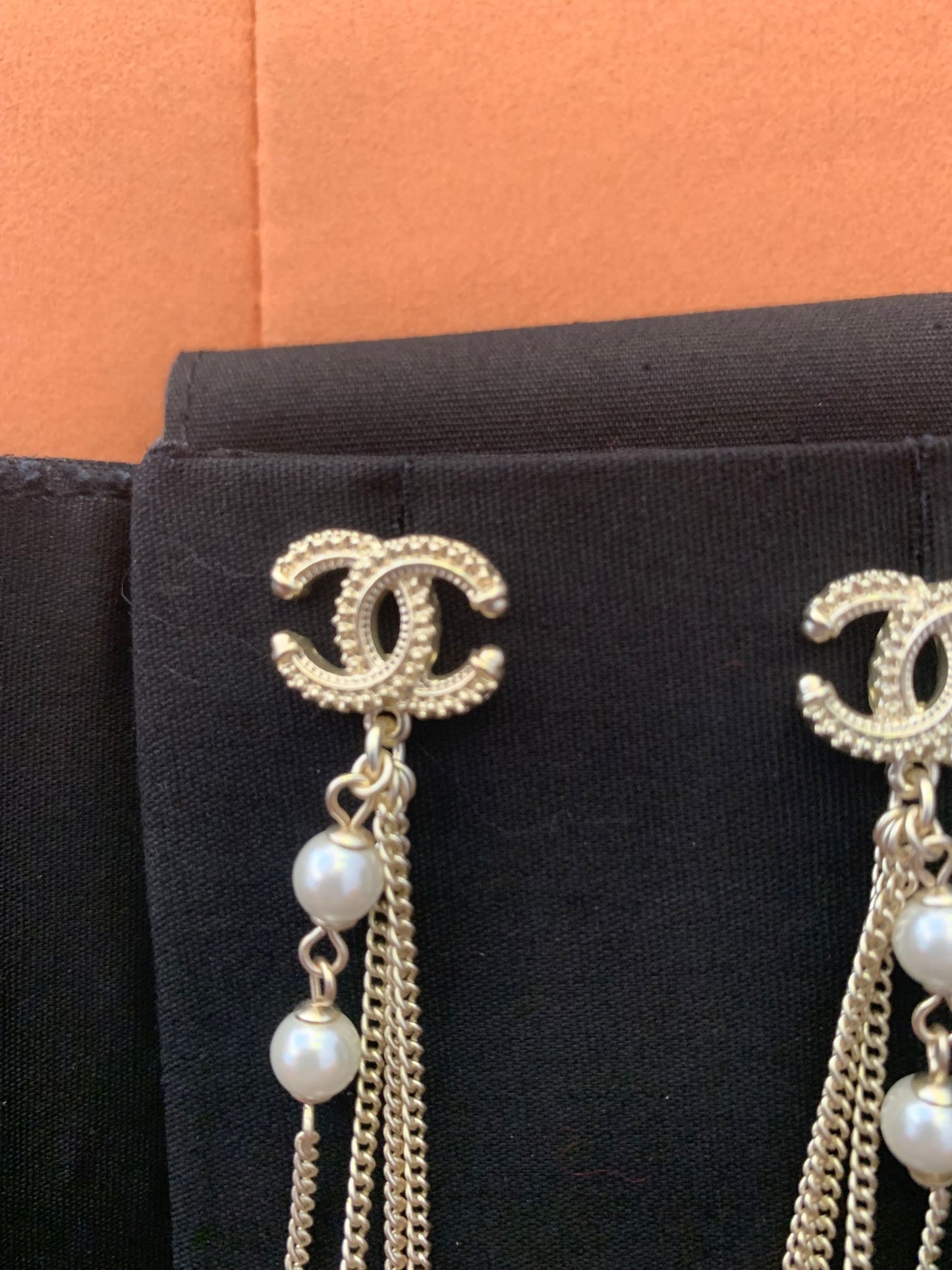 Chanel dangle earrings with CC logo and pearl accents