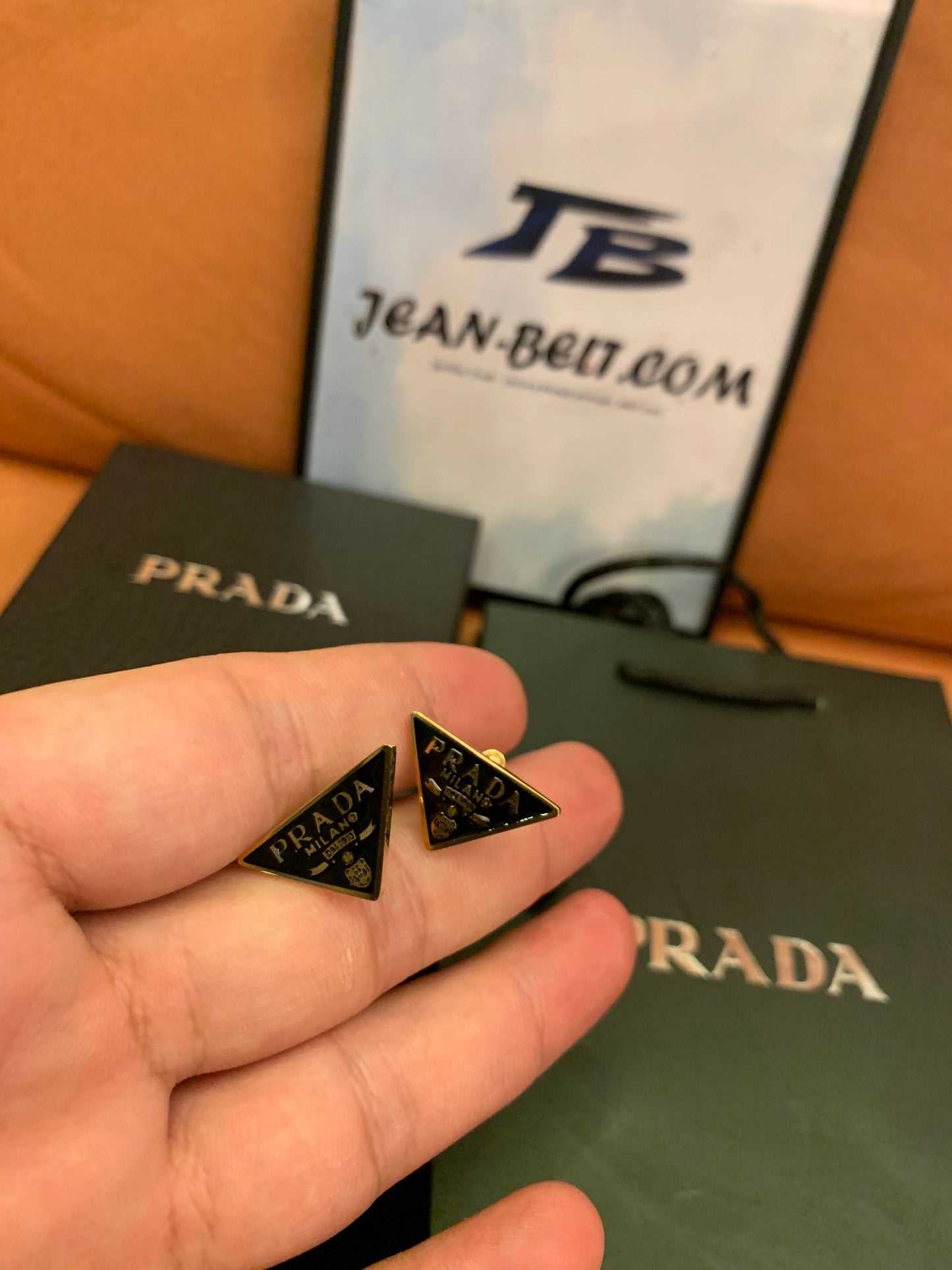 Prada Triangle logo stud earrings in black and gold