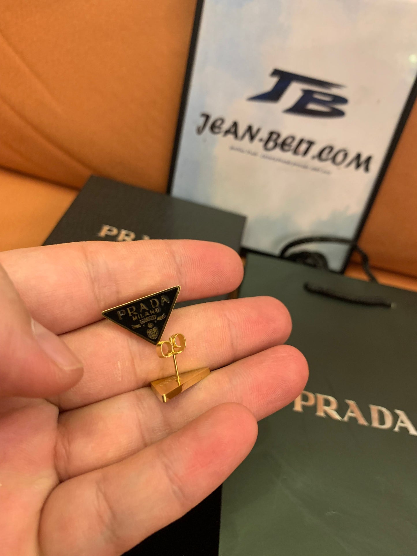 Prada Triangle logo stud earrings in black and gold