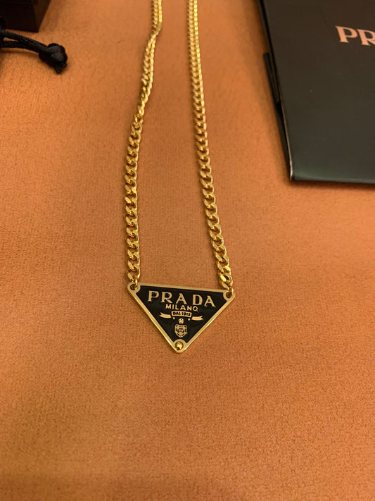 Prada Triangle logo pendant necklace in black and gold