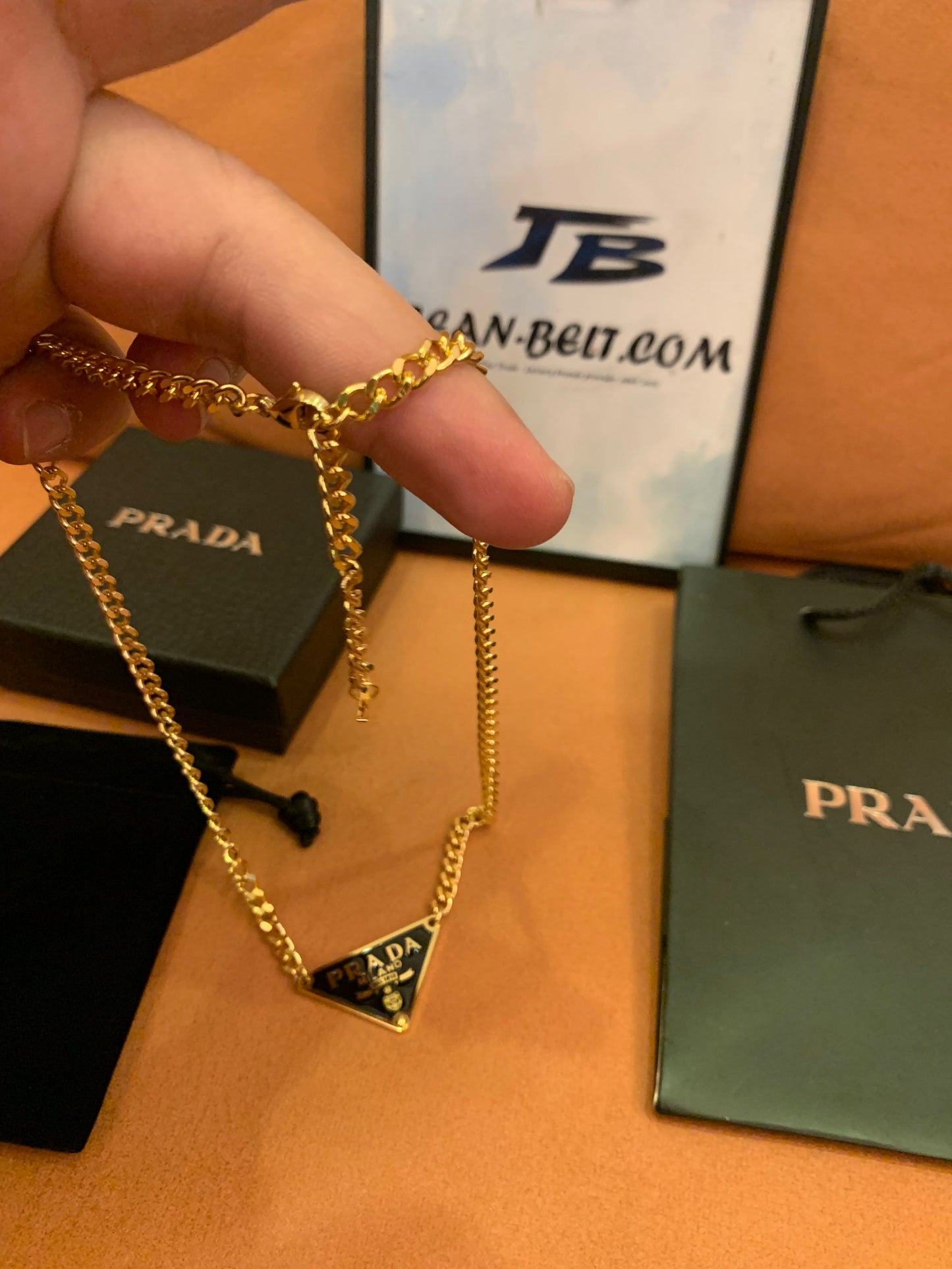 Prada Triangle logo pendant necklace in black and gold