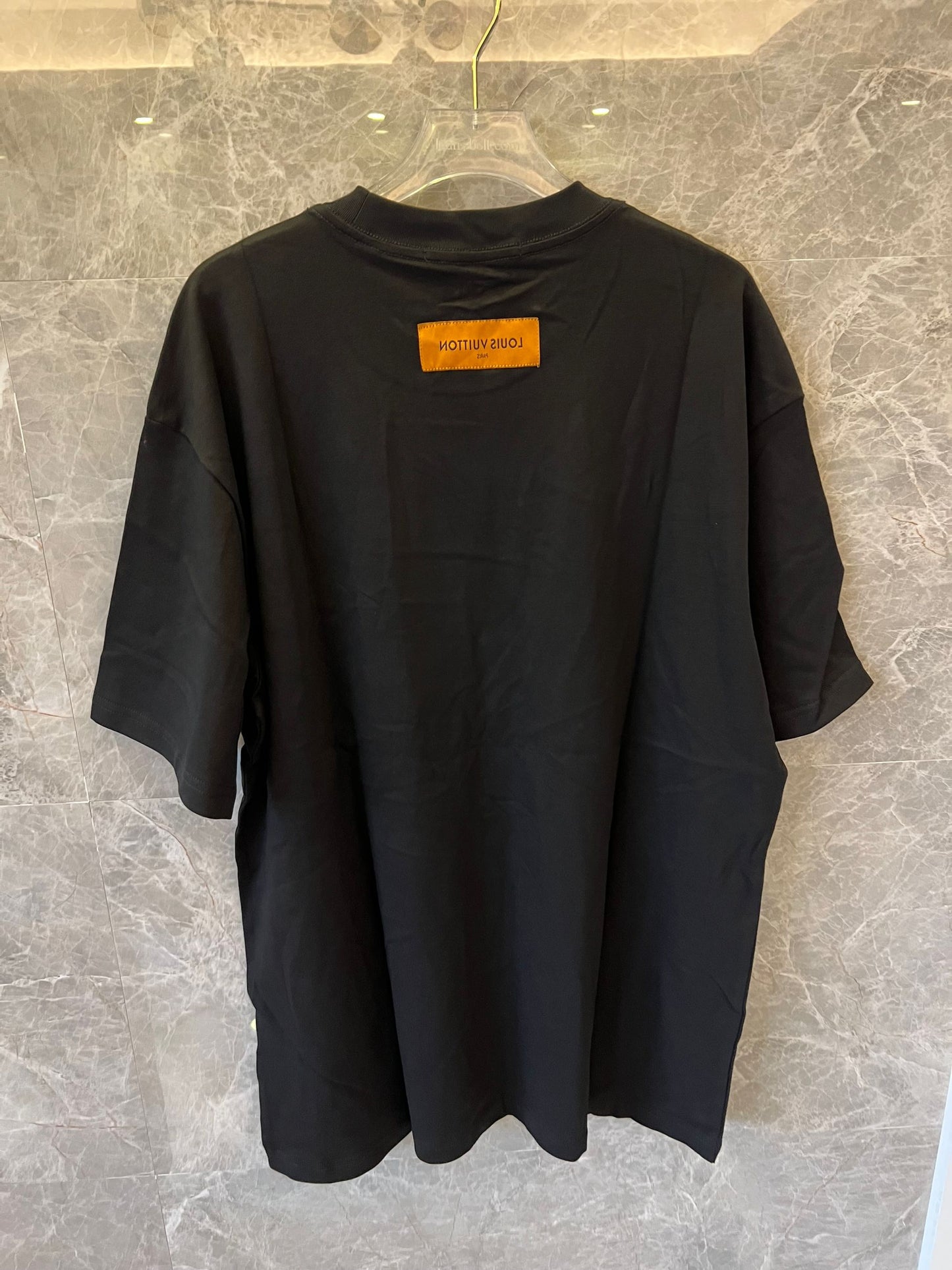 Louis Vuitton black t-shirt with "The Louis Vuittons" graphic and orange paris tag