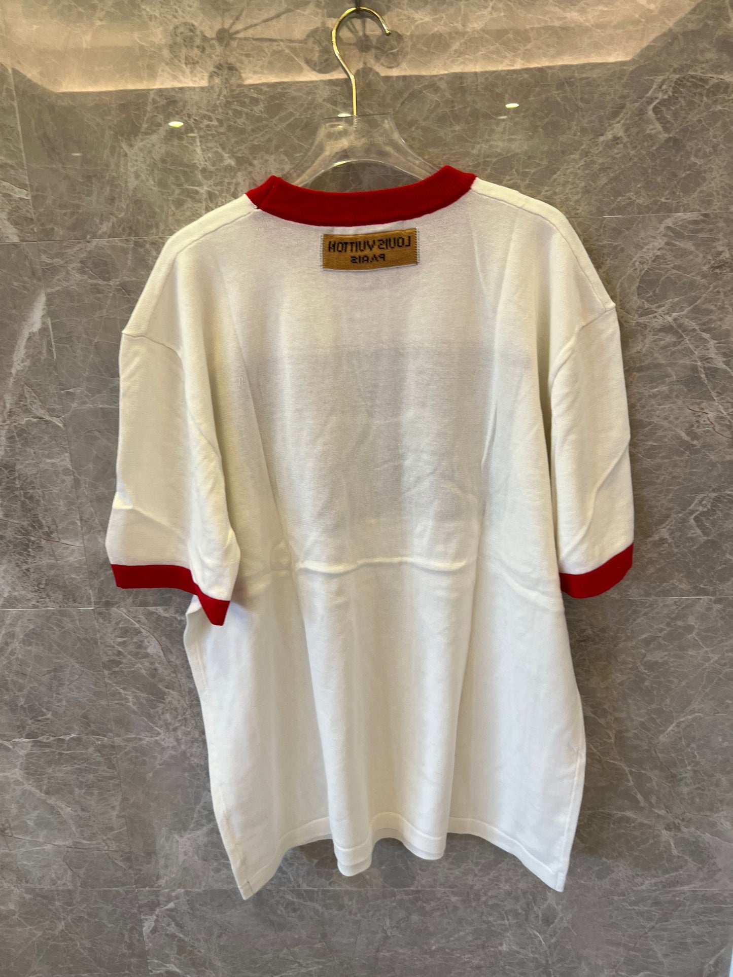 Louis Vuitton white t-shirt with bold LV logo and red ribbed accents