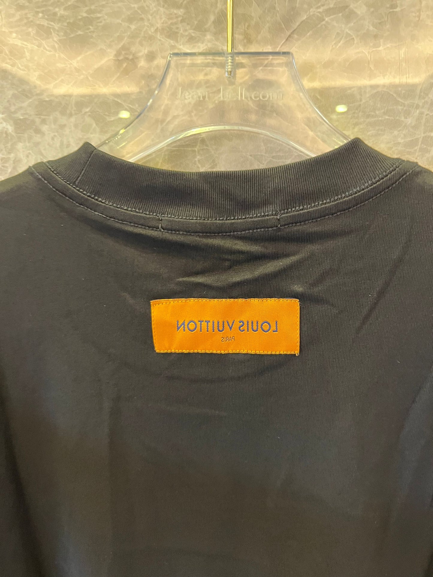 Louis Vuitton black t-shirt with "The Louis Vuittons" graphic and orange paris tag