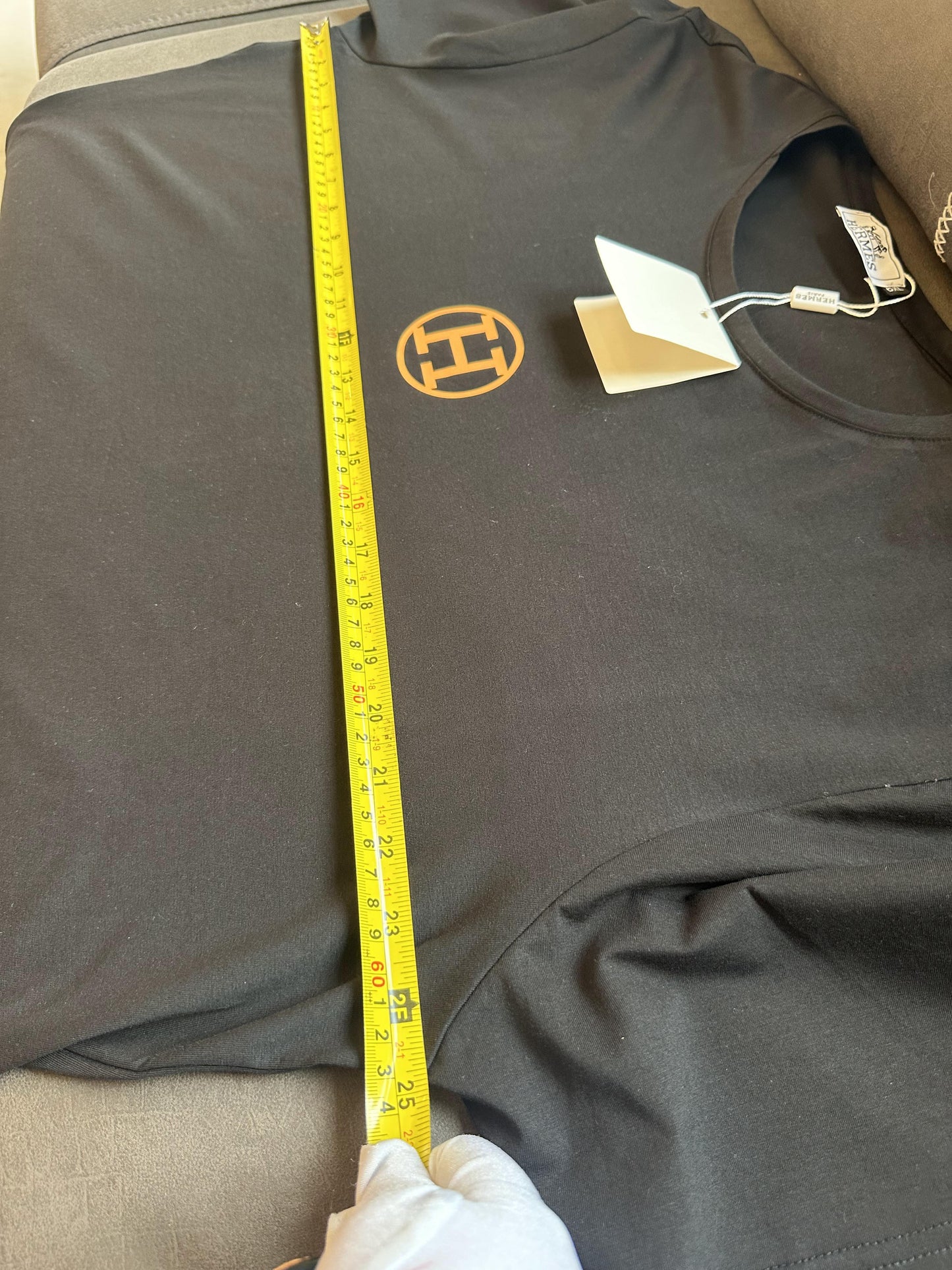 Hermès black t-shirt with gold logo and branding