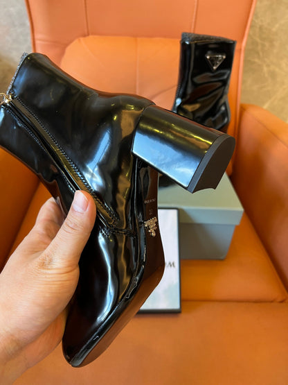 Prada leather ankle boots with iconic metal triangle