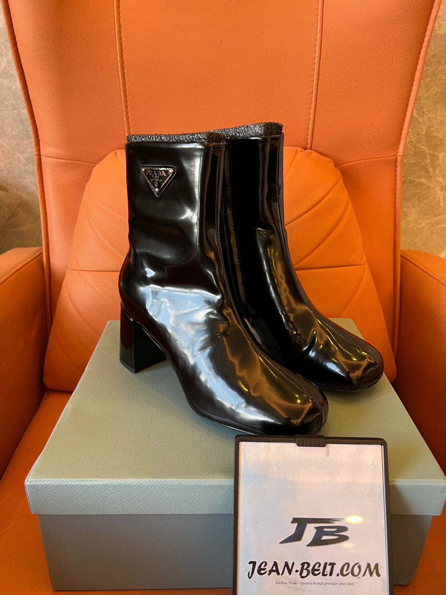 Prada leather ankle boots with iconic metal triangle