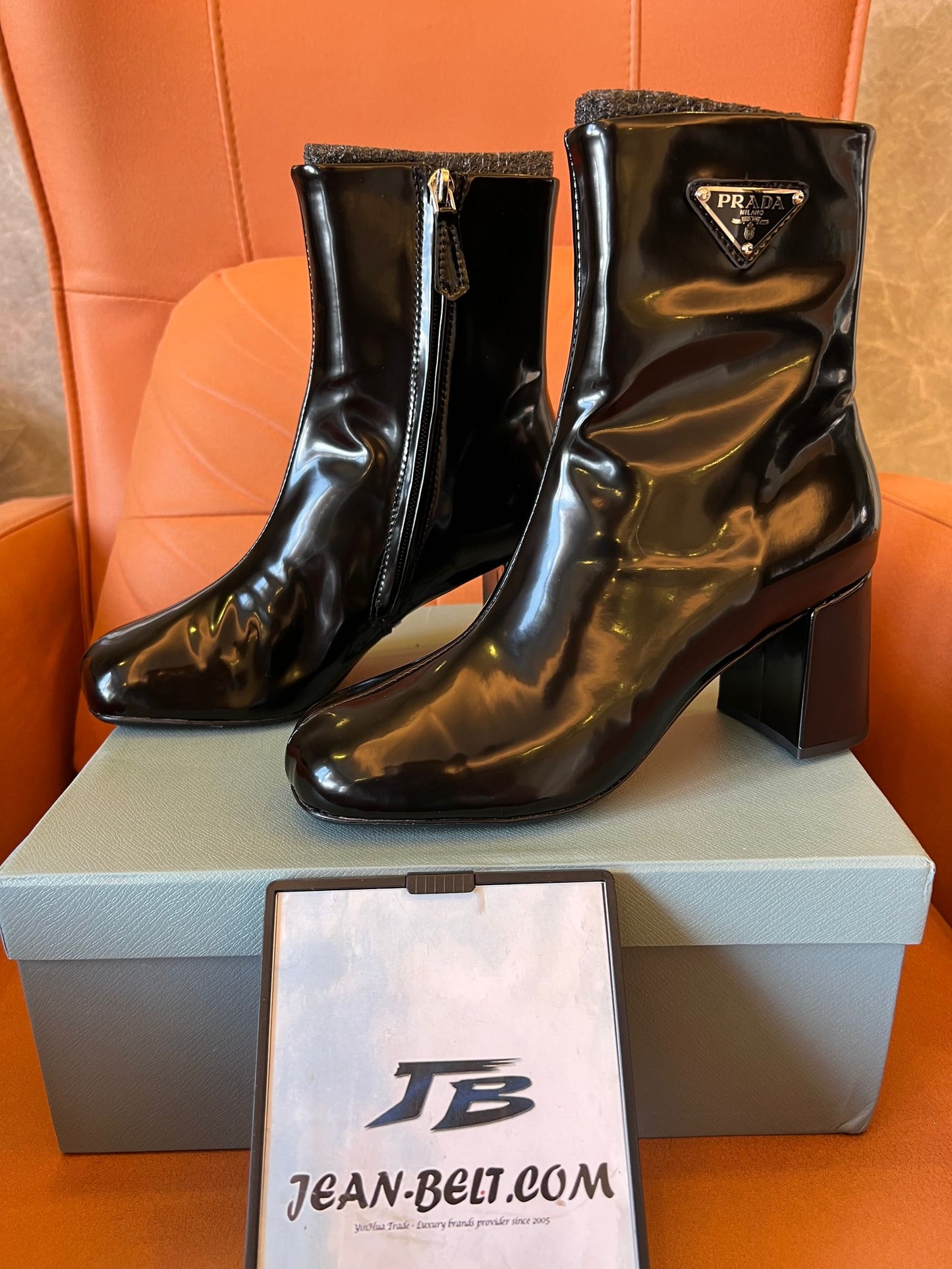 Prada leather ankle boots with iconic metal triangle