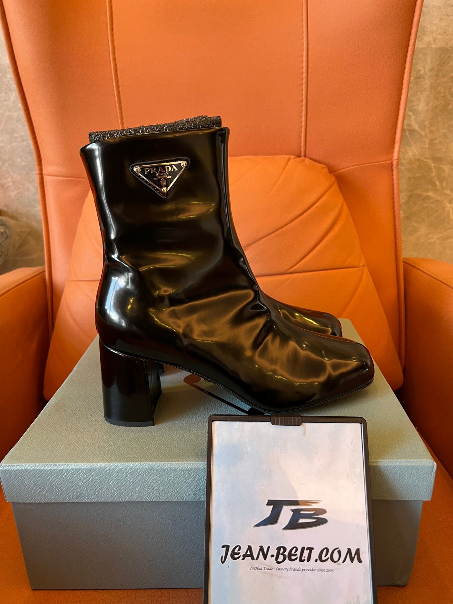 Prada leather ankle boots with iconic metal triangle