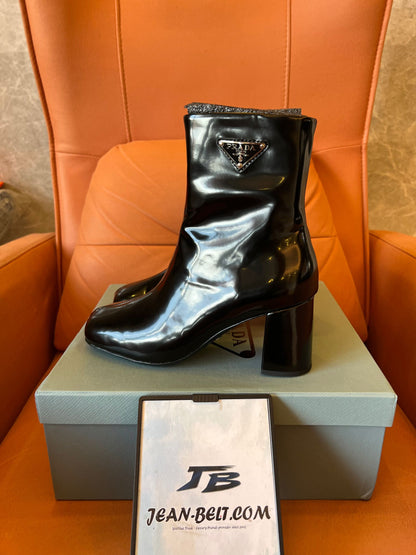 Prada leather ankle boots with iconic metal triangle