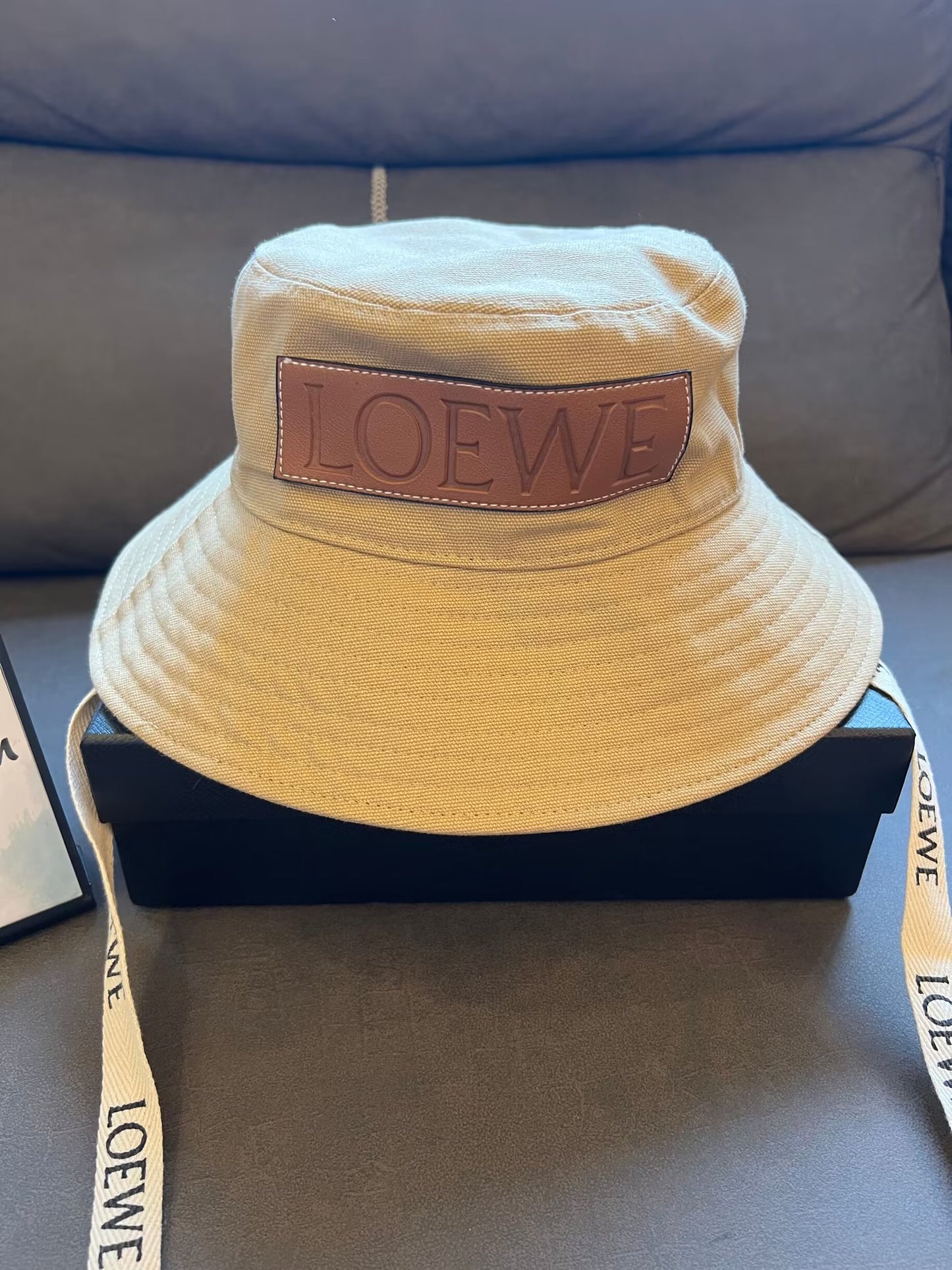 Loewe canvas bucket hat with leather logo patch and branded straps