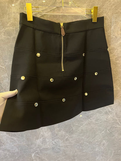 Louis Vuitton black mini skirt with gold zipper and monogram accents