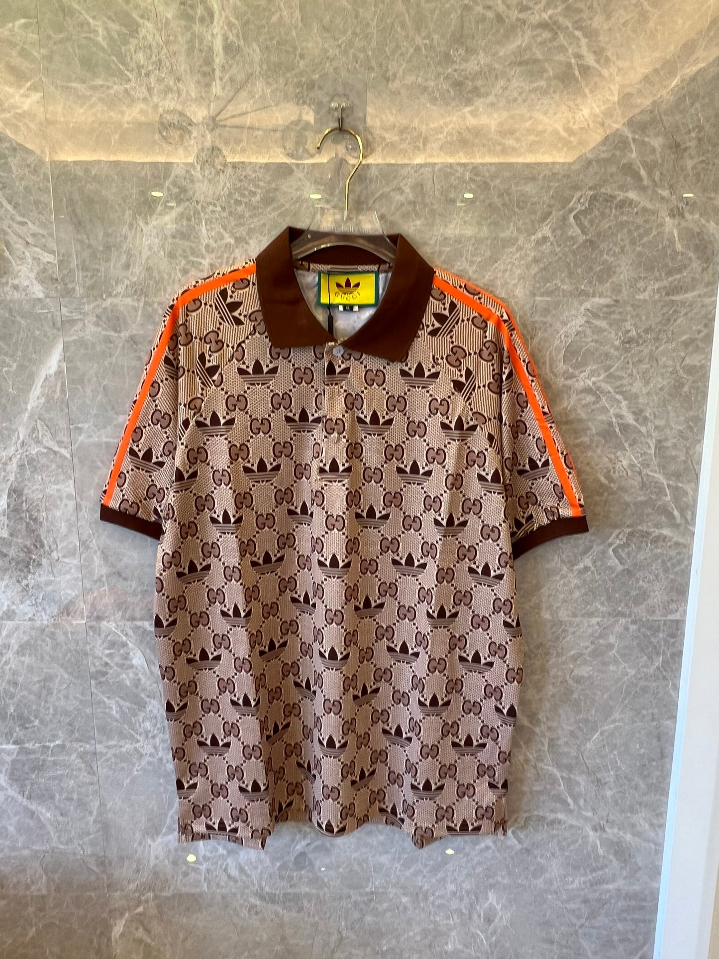 Gucci x Adidas brown monogram polo shirt with orange trim and trefoil logos