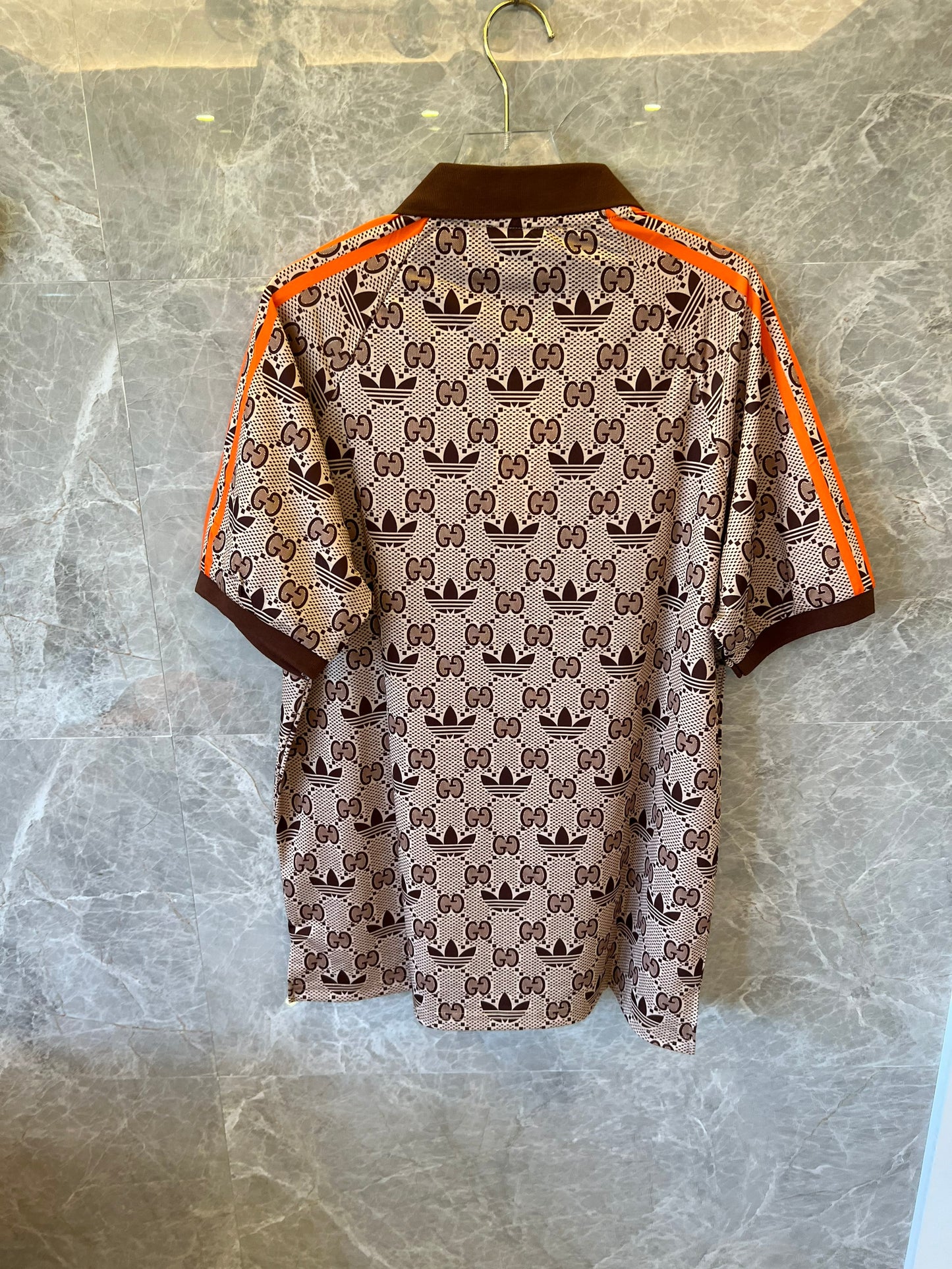 Gucci x Adidas brown monogram polo shirt with orange trim and trefoil logos