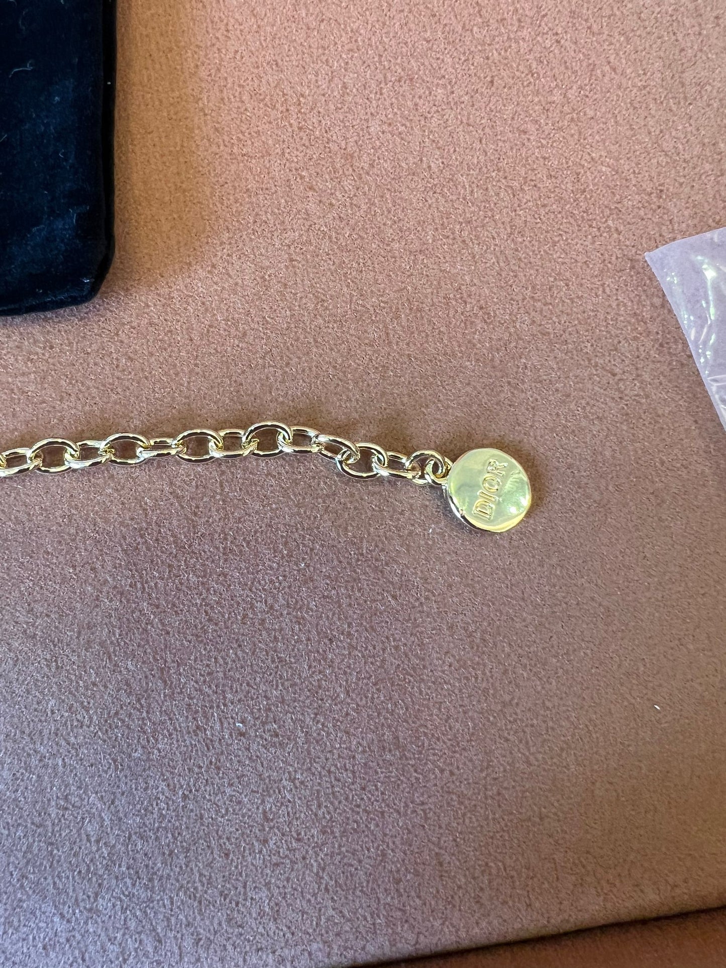 Dior gold chain bracelet with iconic CD and heart charms