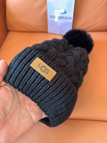 UGG black cable knit beanie with pom-pom and logo plaque