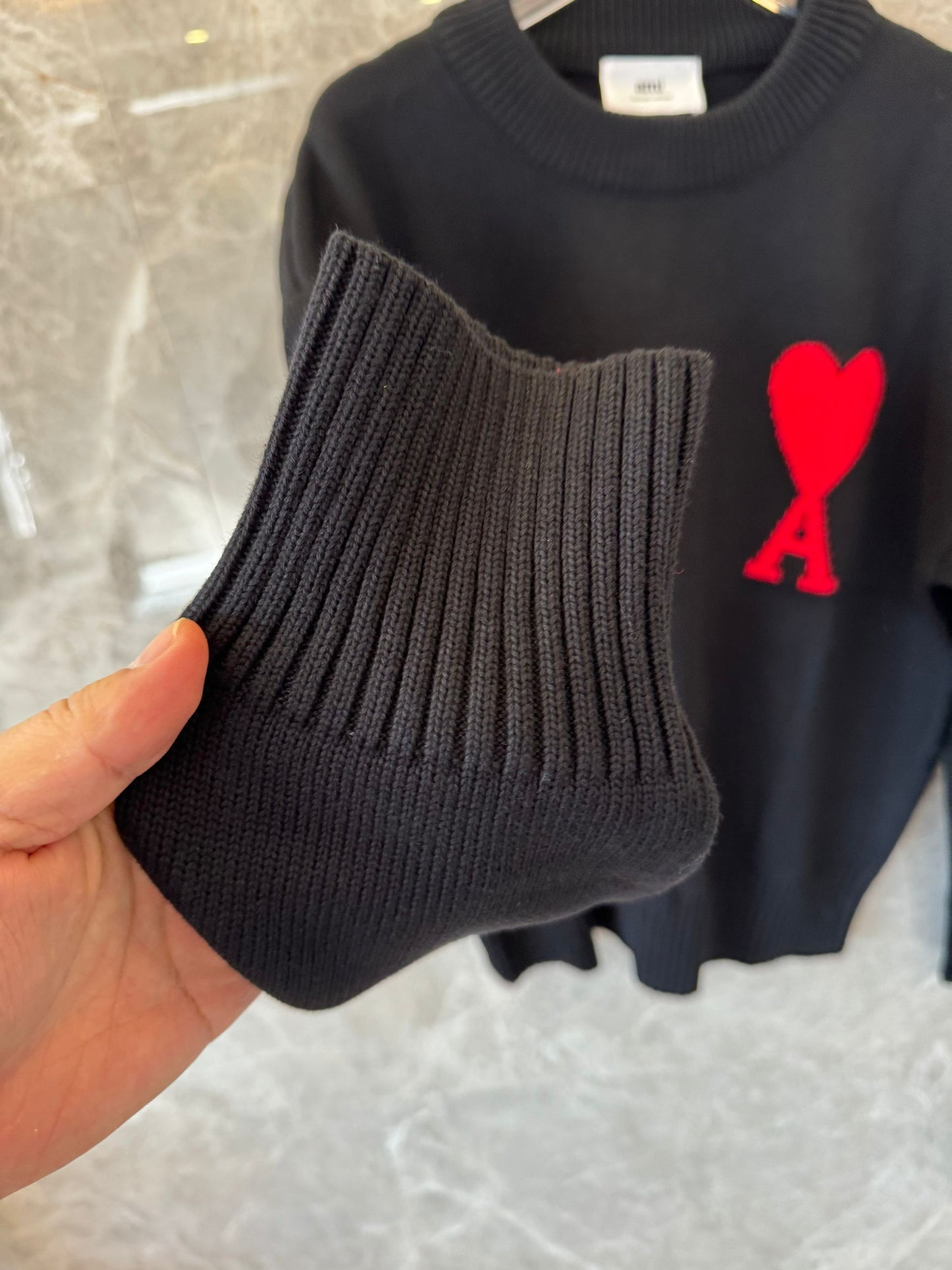 Ami heart embroidered black knit sweater - cozy pullover with signature red "A" logo