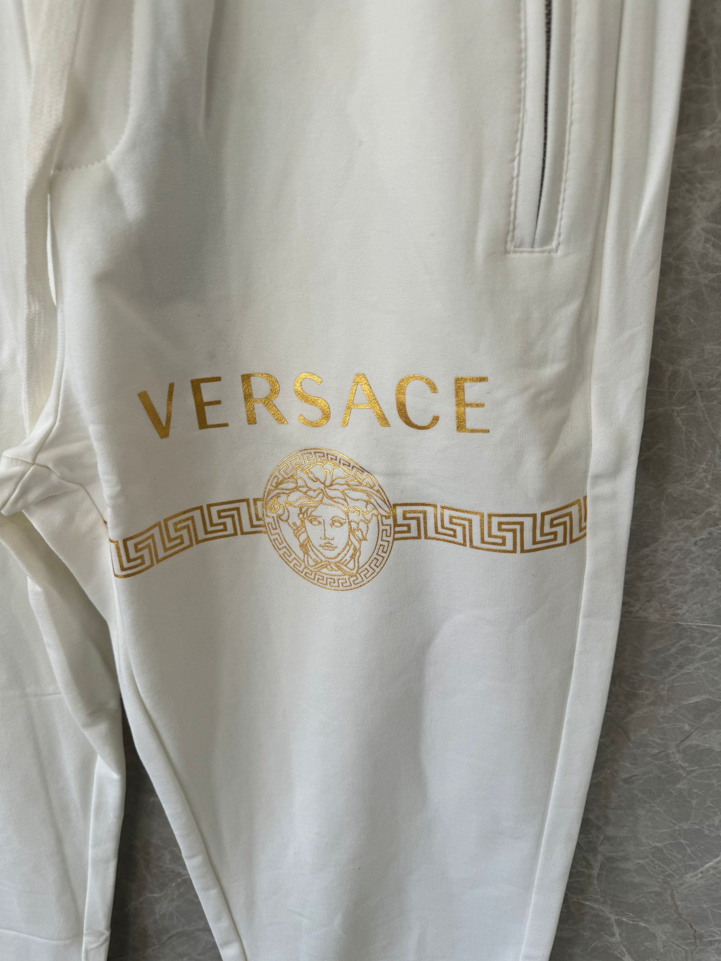 Versace white joggers with gold medusa logo and greek key print