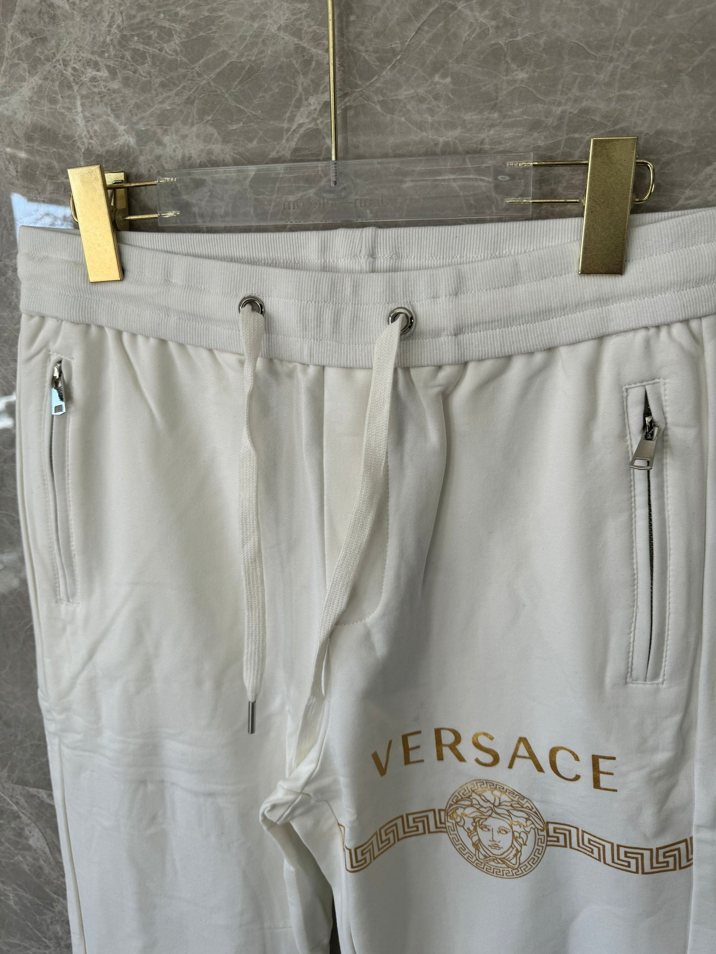 Versace white joggers with gold medusa logo and greek key print