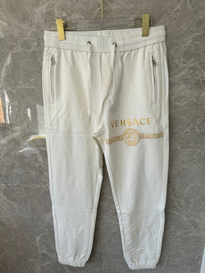 Versace white joggers with gold medusa logo and greek key print