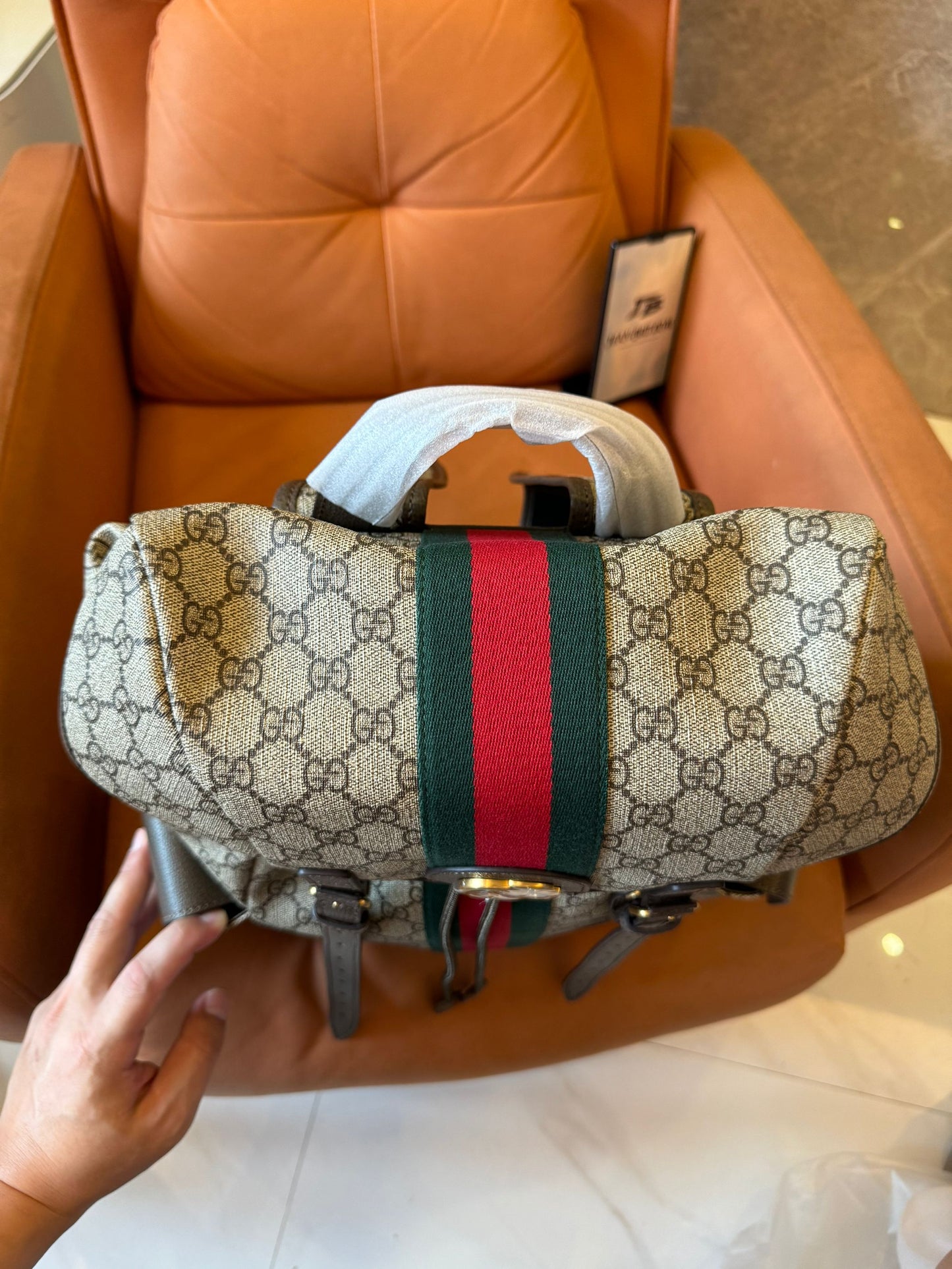 Gucci GG Supreme canvas backpack with web stripe and double buckle design