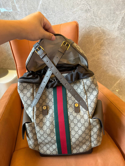 Gucci GG Supreme canvas backpack with web stripe and double buckle design