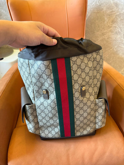 Gucci GG Supreme canvas backpack with web stripe and double buckle design