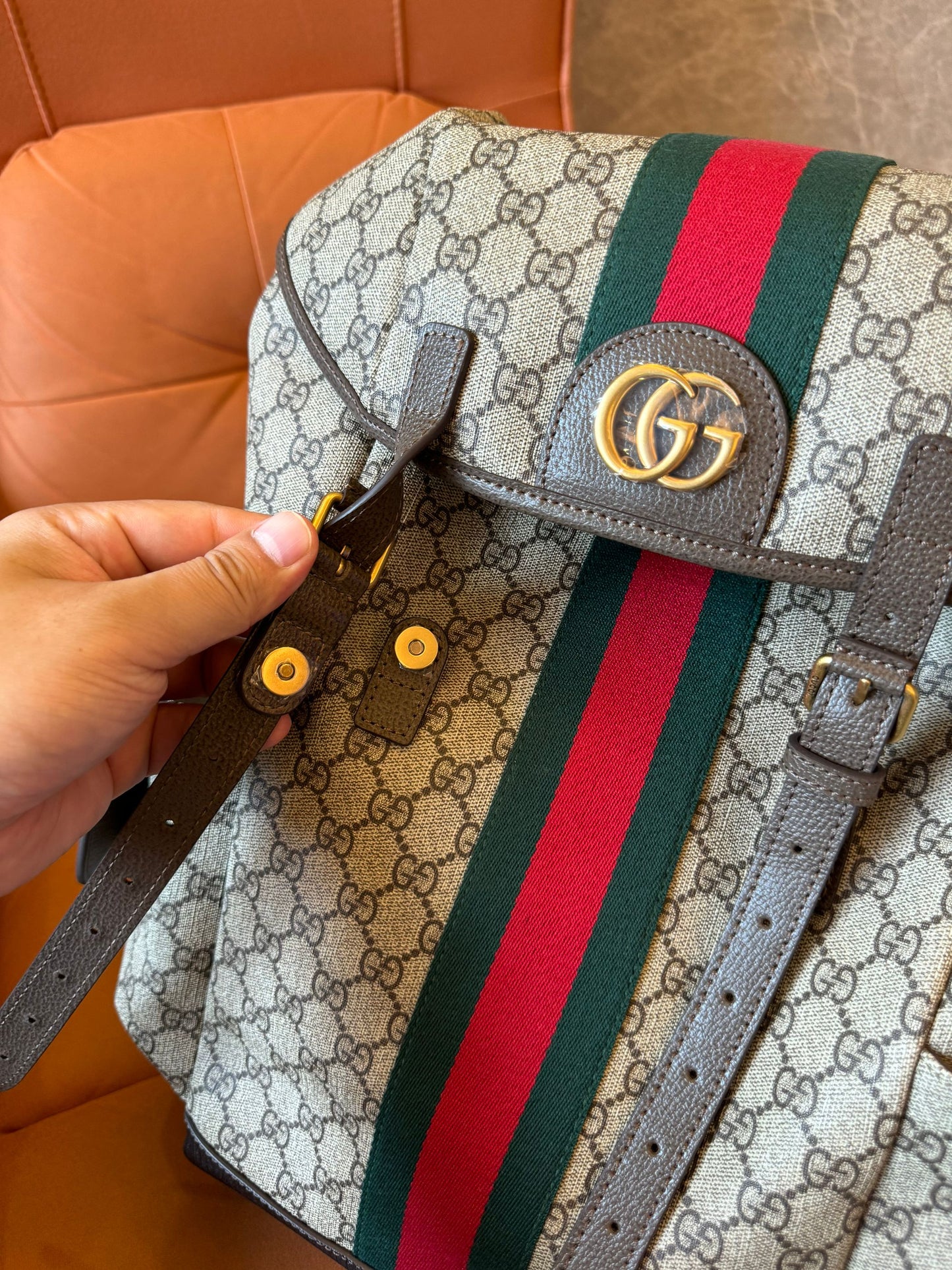 Gucci GG Supreme canvas backpack with web stripe and double buckle design