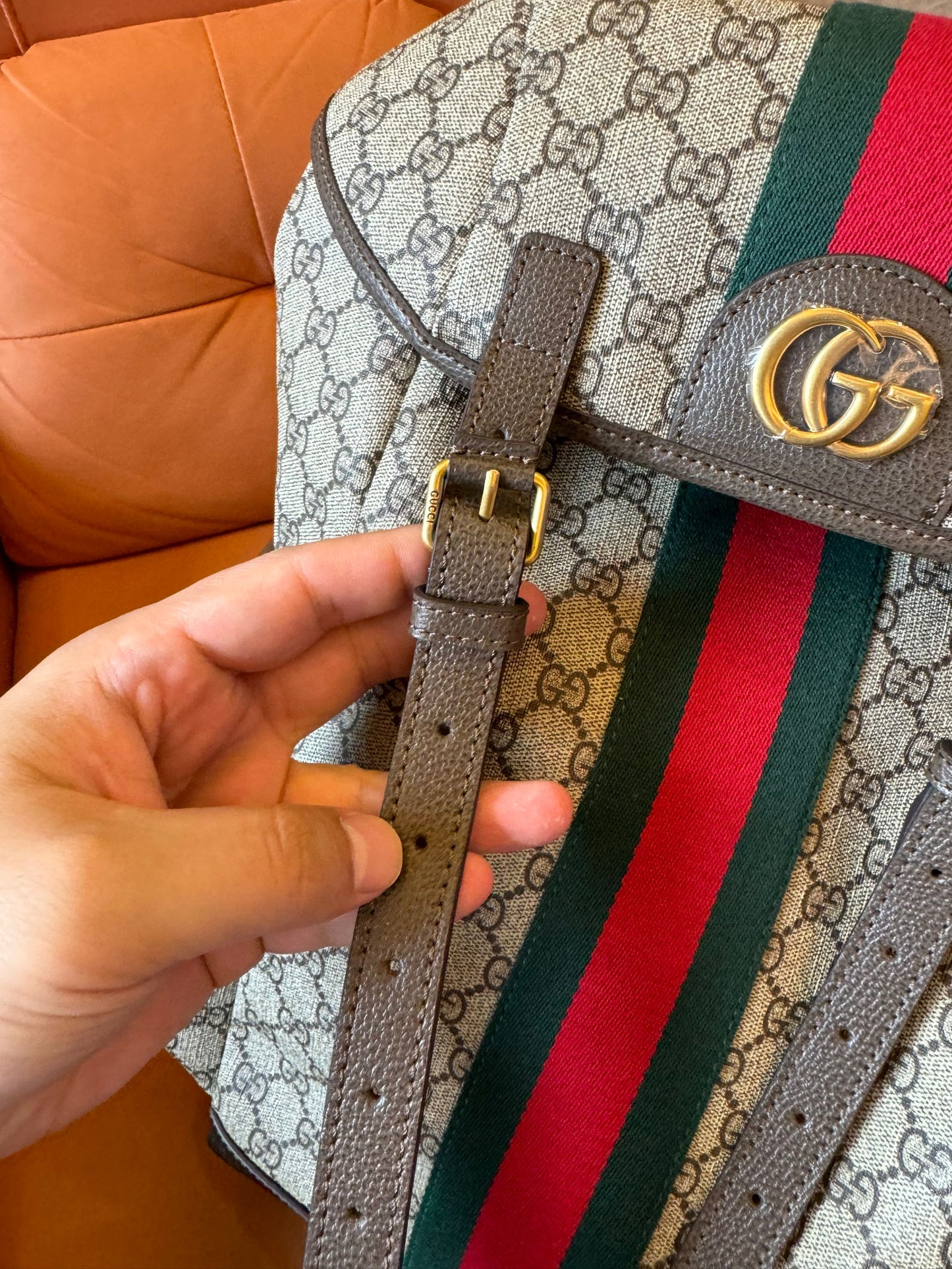 Gucci GG Supreme canvas backpack with web stripe and double buckle design