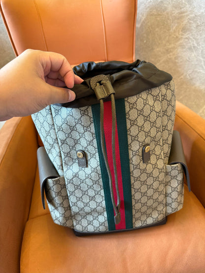 Gucci GG Supreme canvas backpack with web stripe and double buckle design