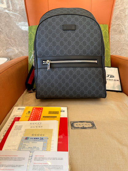 Gucci GG Supreme backpack with red and blue straps