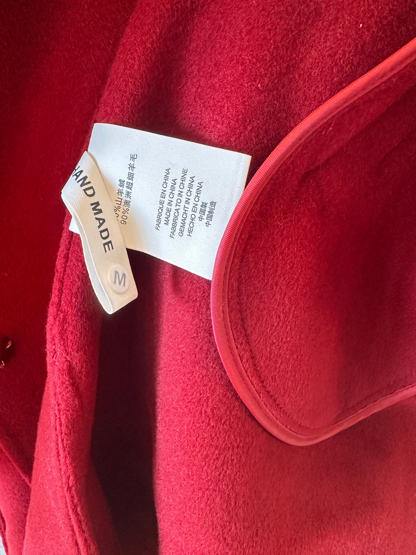 Hermes red wool coat with asymmetric collar and leather buckle