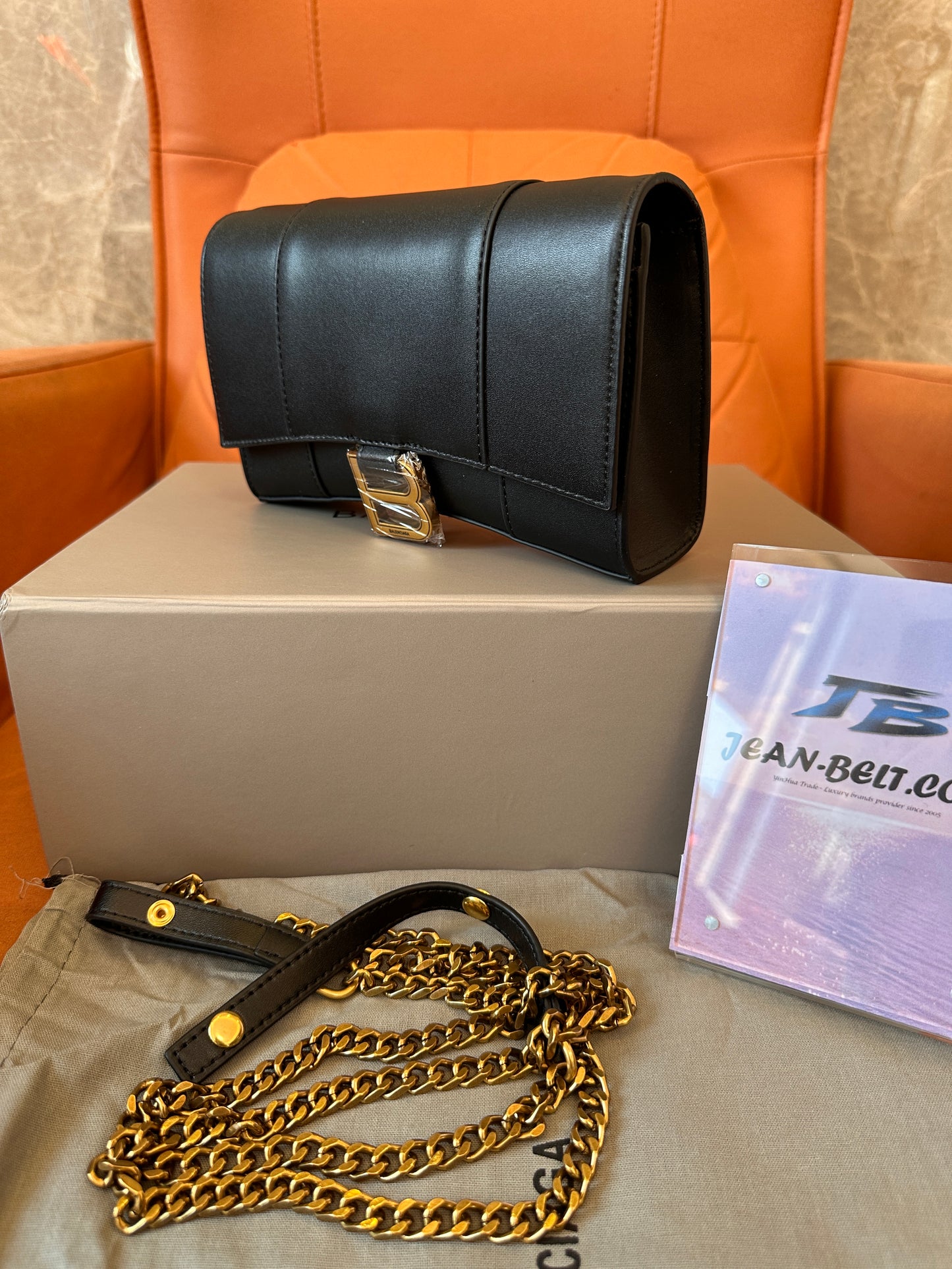 Balenciaga B clutch bag with gold chain strap