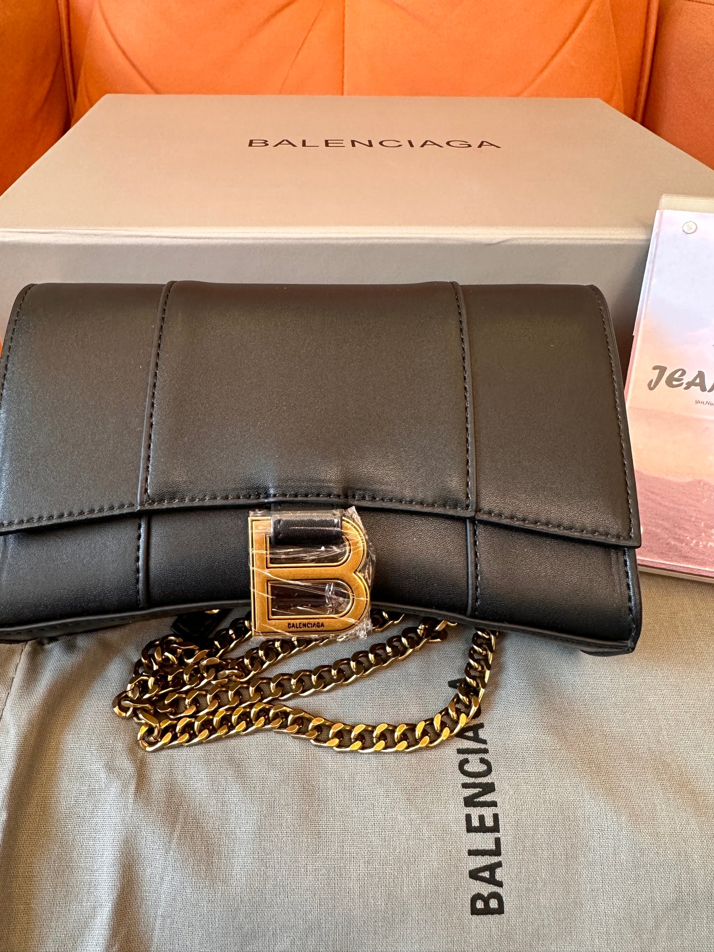 Balenciaga B clutch bag with gold chain strap